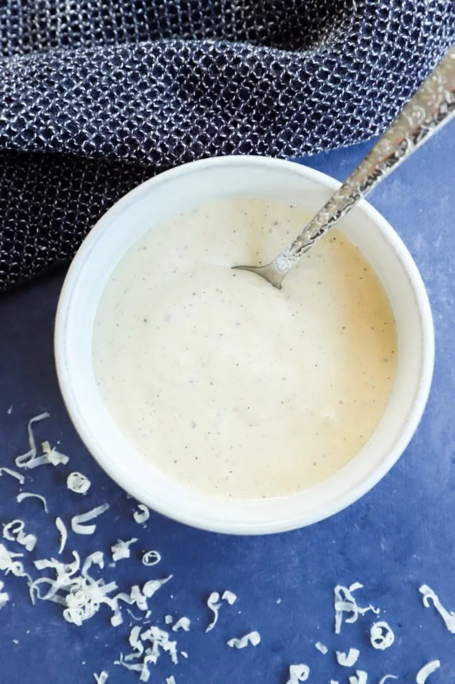 bowl of caesar dressing with a spoon in it