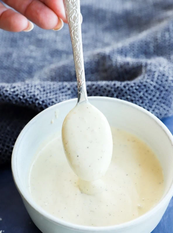 spoonful of salad sauce that's creamy in a bowl