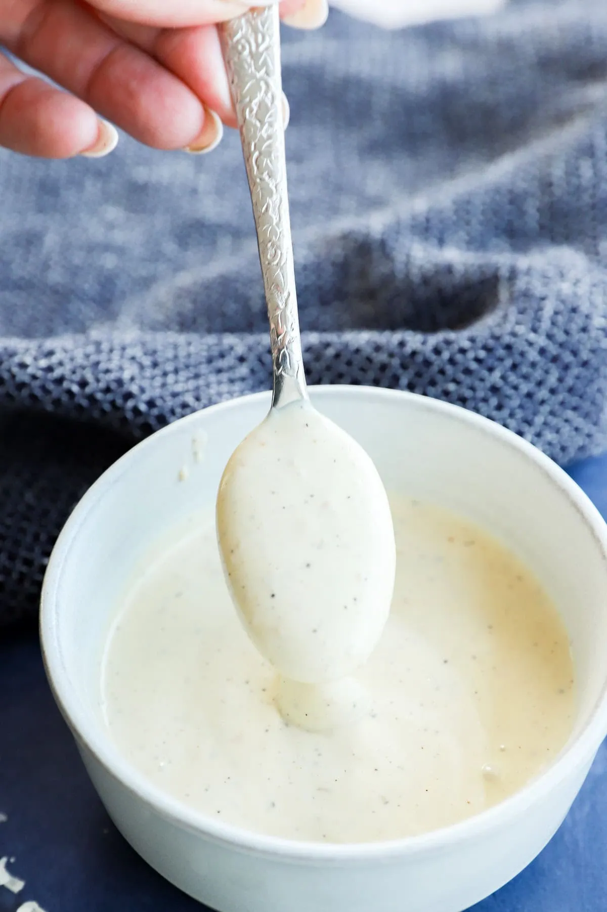 spoonful of salad sauce that's creamy in a bowl