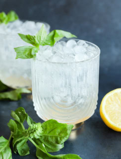 basil cocktail in glasses with fresh basil leaves lemon