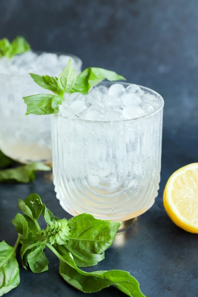 basil cocktail in glasses with fresh basil leaves lemon