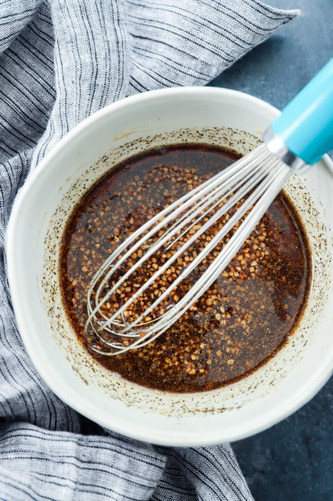 honey soy marinade in a bowl with a whisk and linen towel