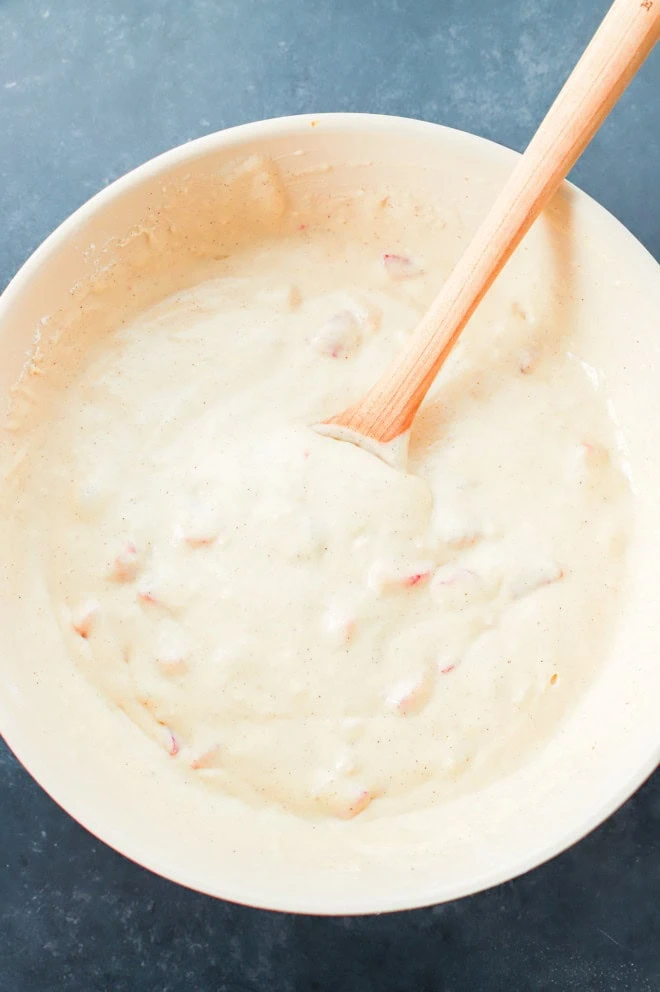 strawberry waffles batter in bowl with wooden spoon