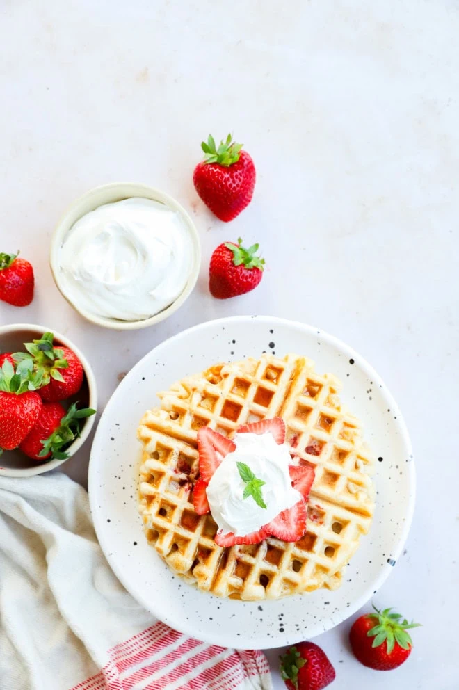 plate with berry breakfast with whipped cream