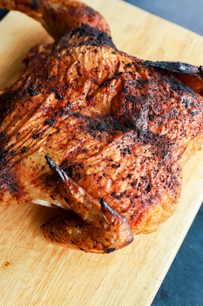 grilled full chicken on cutting board image