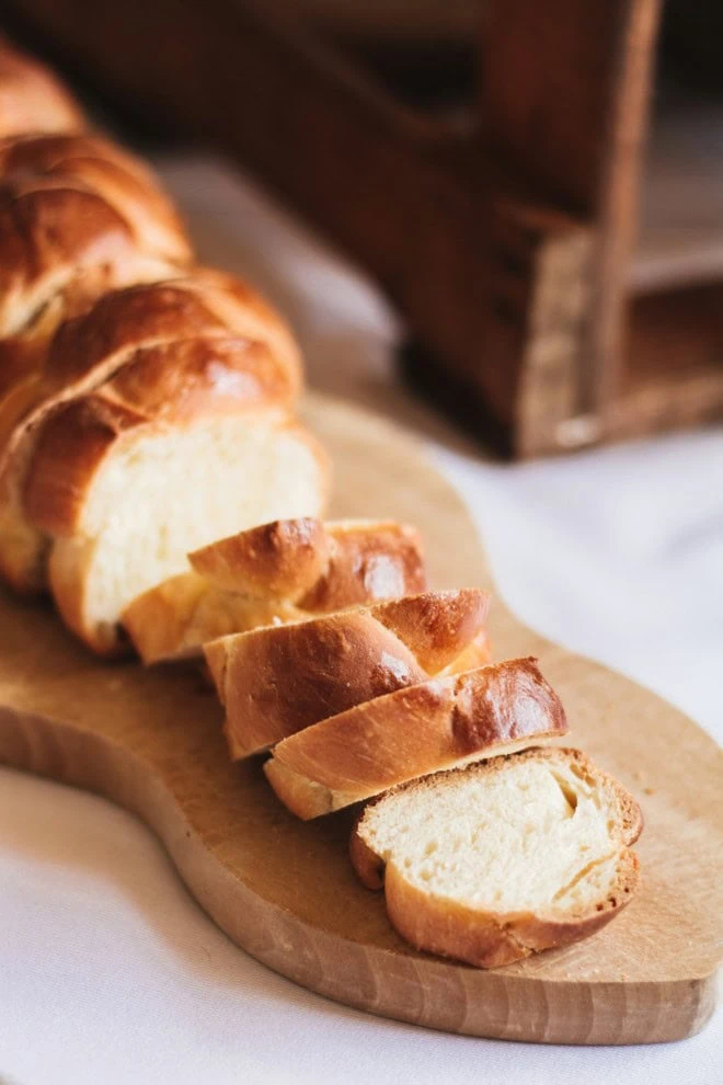 challah bread sliced on cutting board