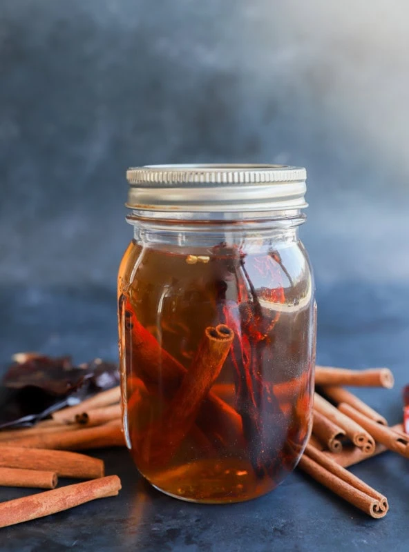 homemade cinnamon whiskey in a jar infusing image