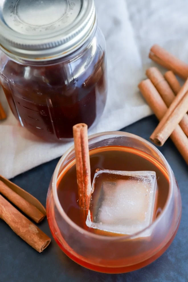 homemade infused bourbon with ice cube and warming spices