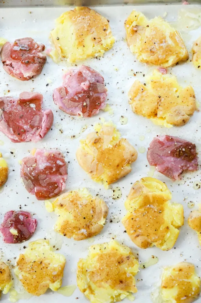 smashed potatoes on a baking sheet before baking