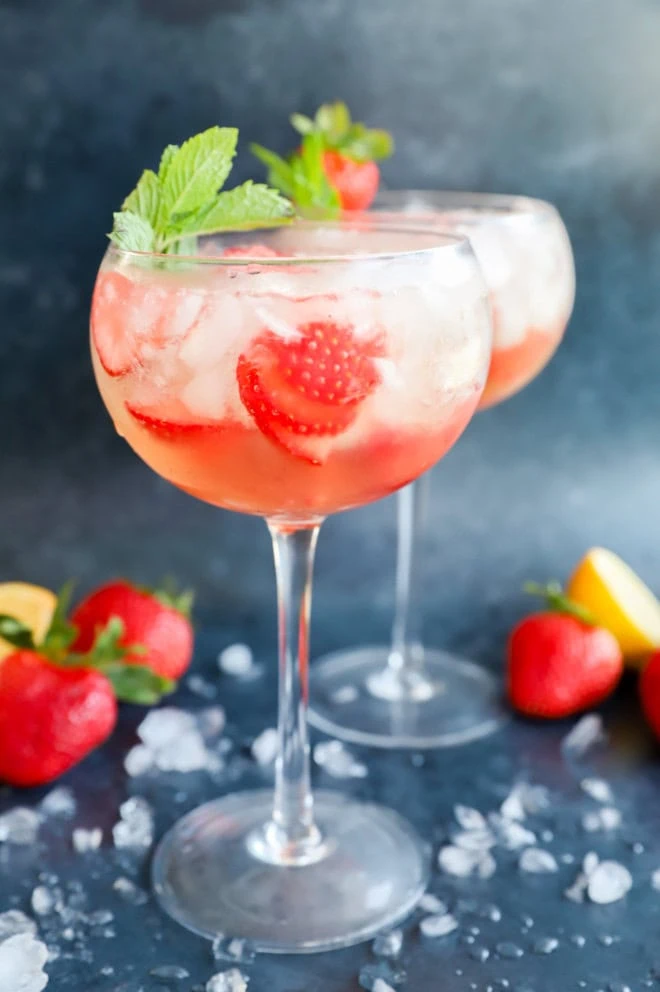 fruity lillet spritz in wine glasses with mint sprigs and crushed ice