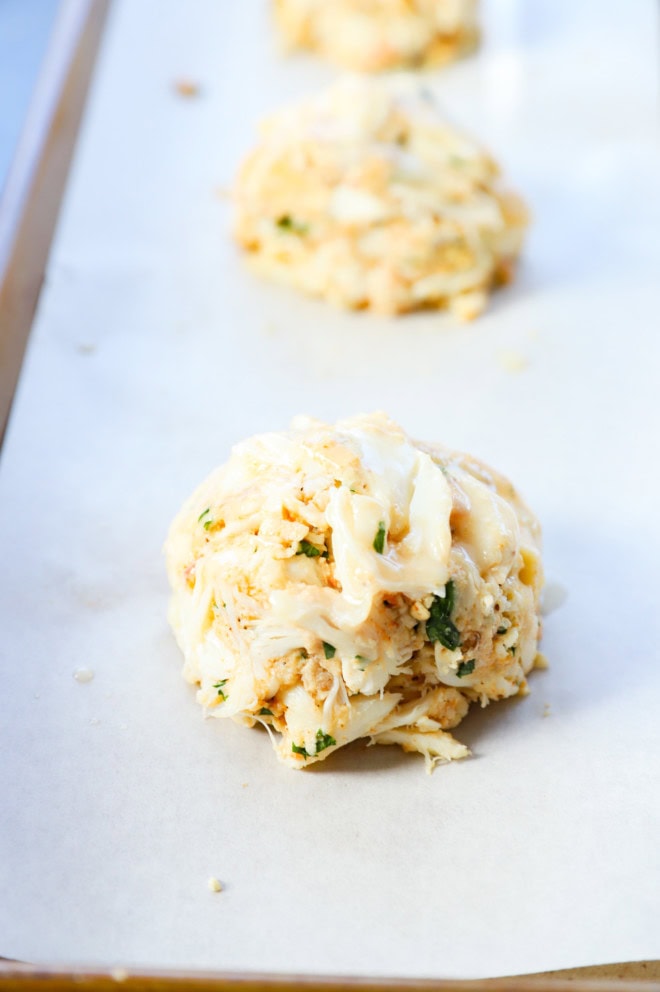 baked crab cakes brushed with butter before baking