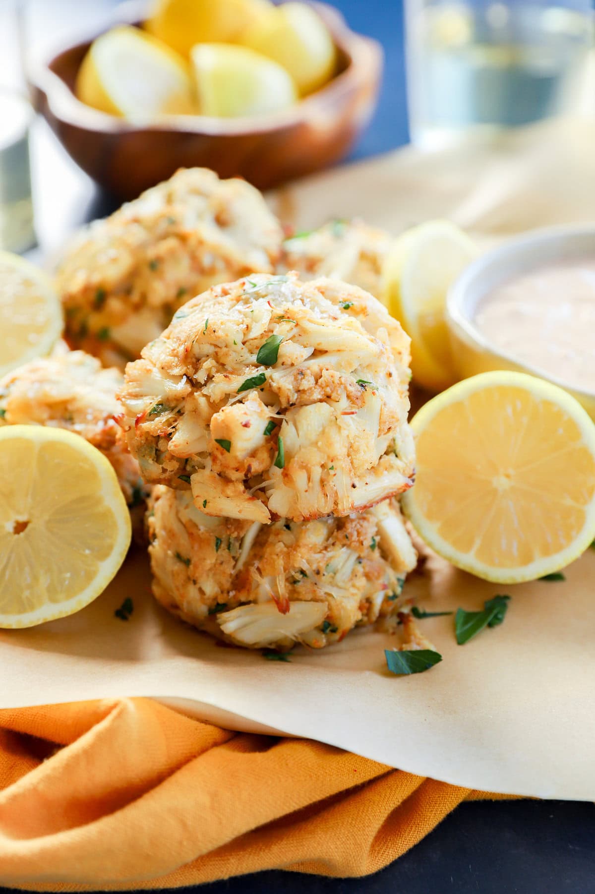 stack of easy seafood appetizer with fresh lemons in bowl and white wine and sauce