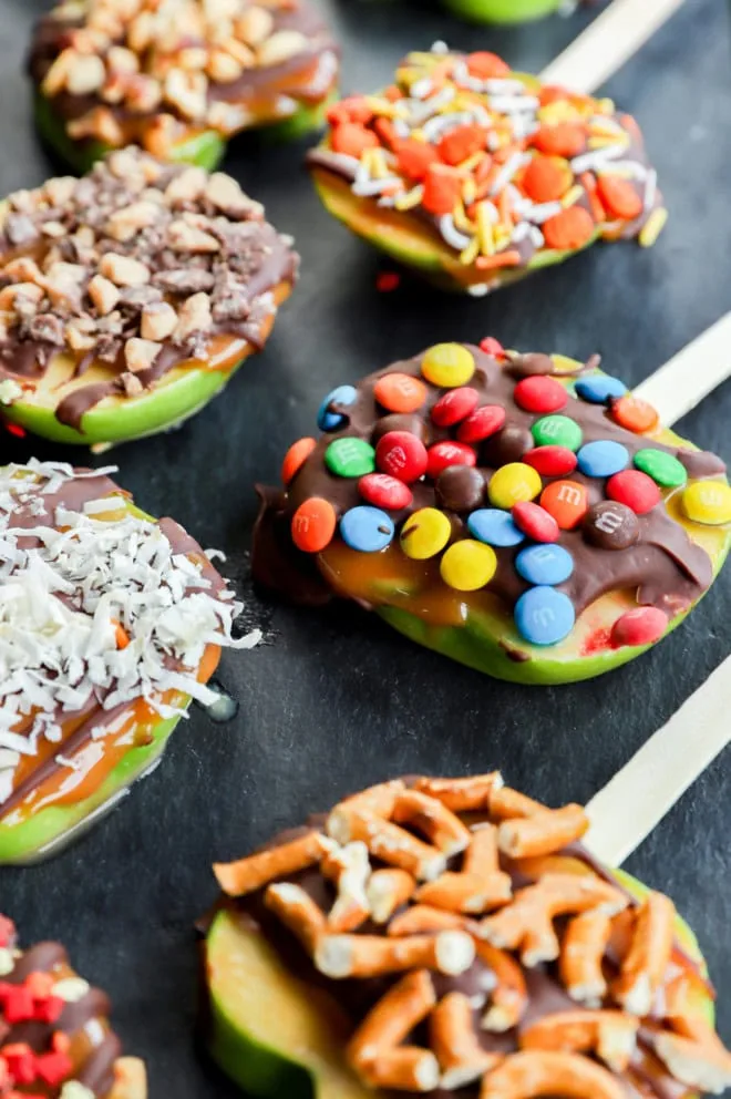 sliced fruit on slate platter with candies on top