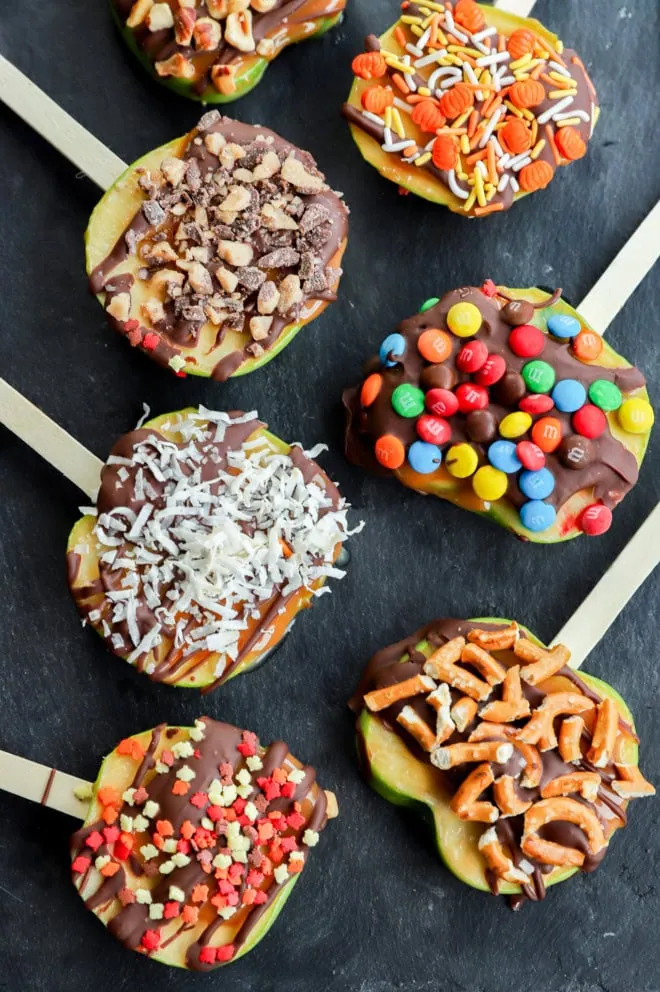 line of sliced fruit with chocolate caramel and other toppings