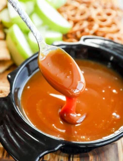 gooey sauce on spoon over a bowl shaped like a bat