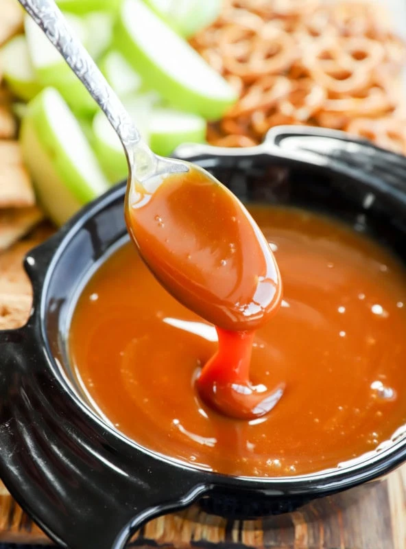 gooey sauce on spoon over a bowl shaped like a bat