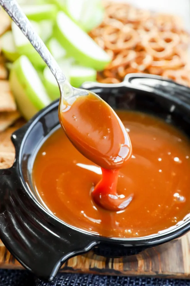 gooey sauce on spoon over a bowl shaped like a bat