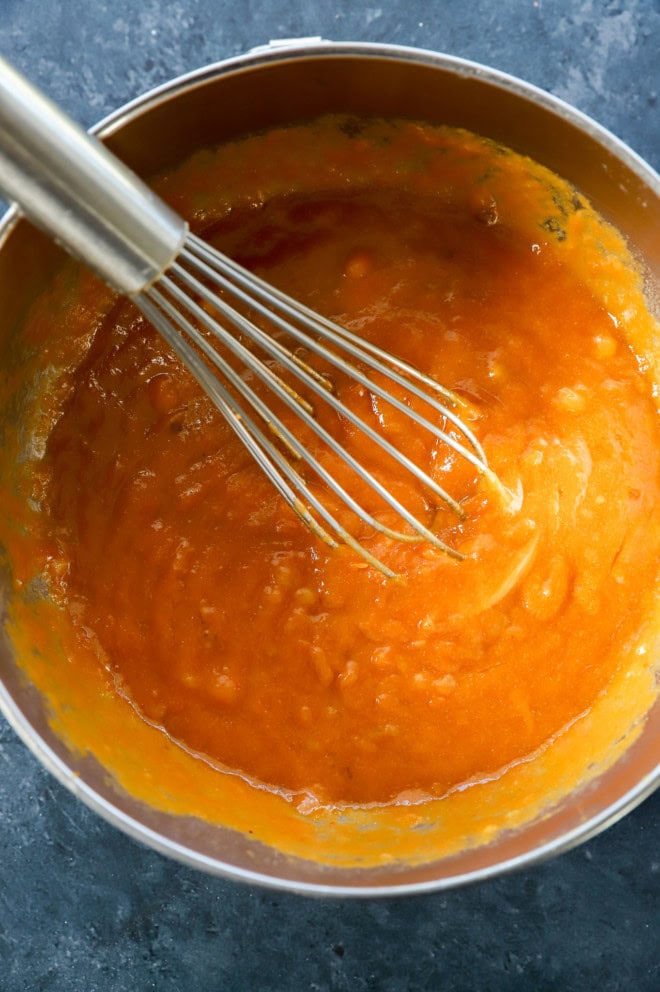 pumpkin puree wet ingredients in bowl with whisk