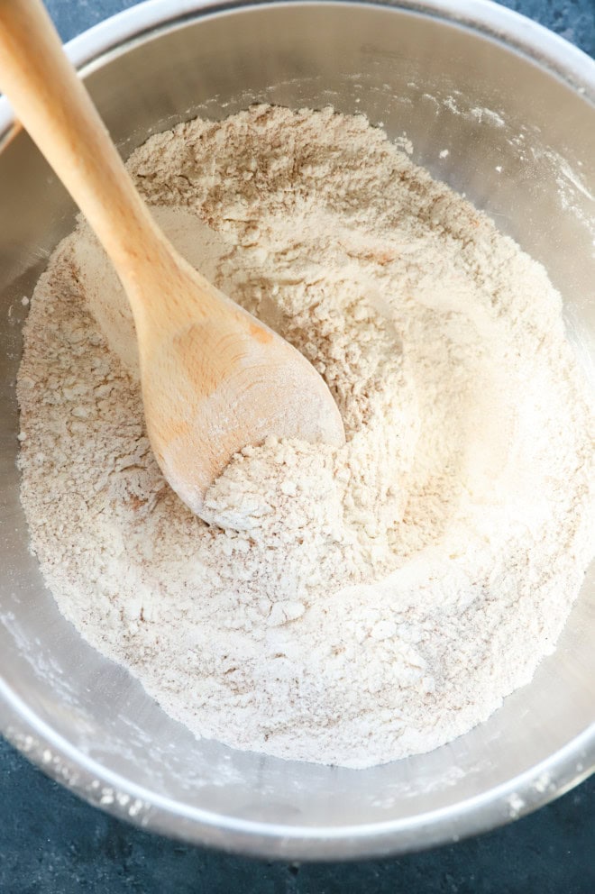 dry ingredients in bowl with wooden spoon