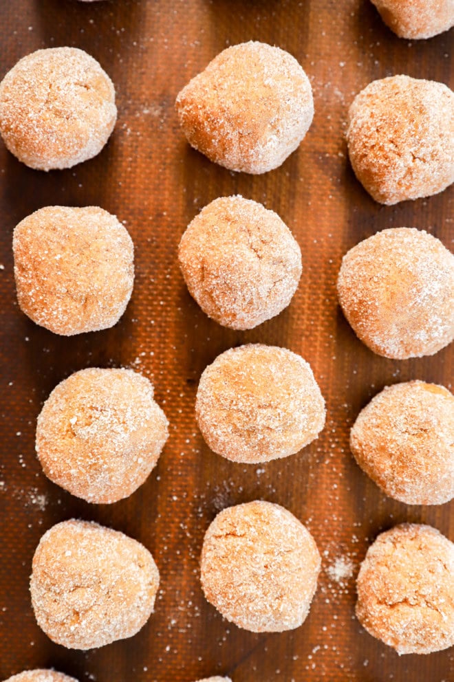 cookie dough balls on lined baking sheet