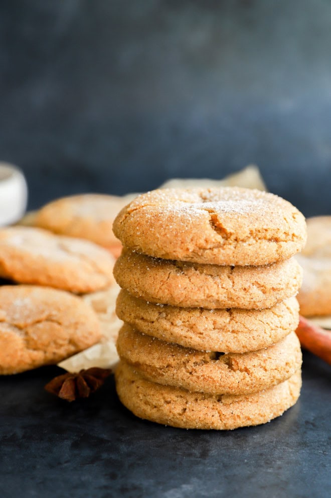 stack of pumpkin pie spice cookies with cinnamon sticks