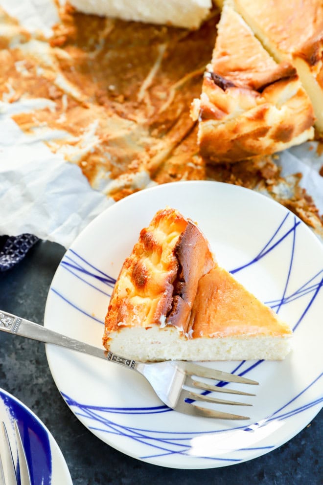 a slice of burnt basque dessert on plate with a fork