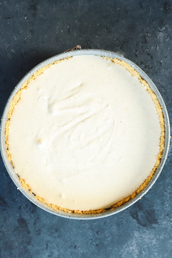 cheesecake filling in graham cracker crust in springform pan