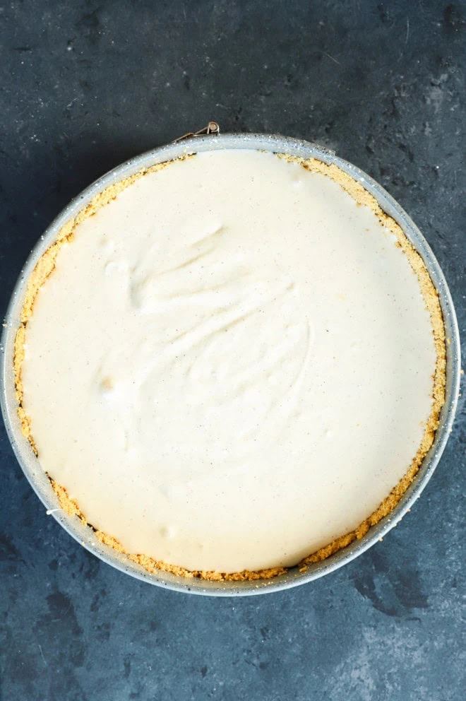 cheesecake filling in graham cracker crust in springform pan