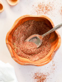 bowl of homemade chili seasoning recipe with spoon and measuring spoons