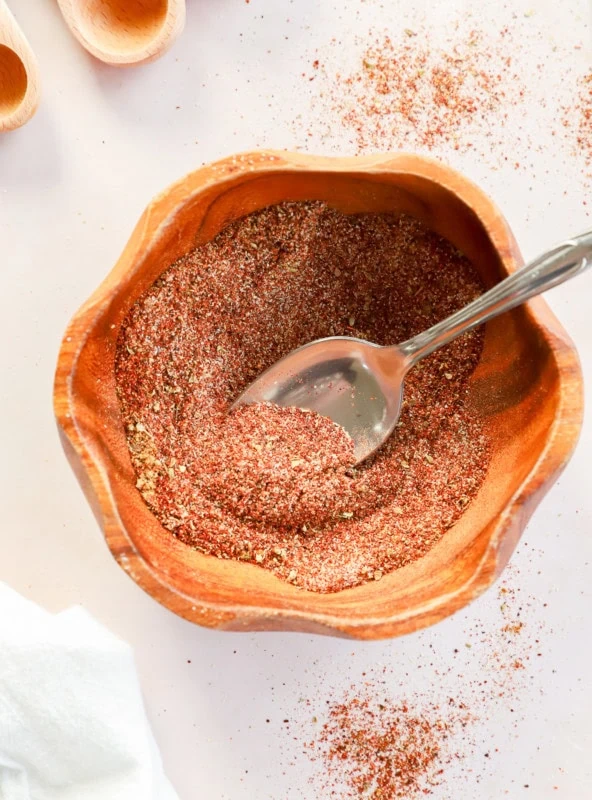 bowl of homemade chili seasoning recipe with spoon and measuring spoons