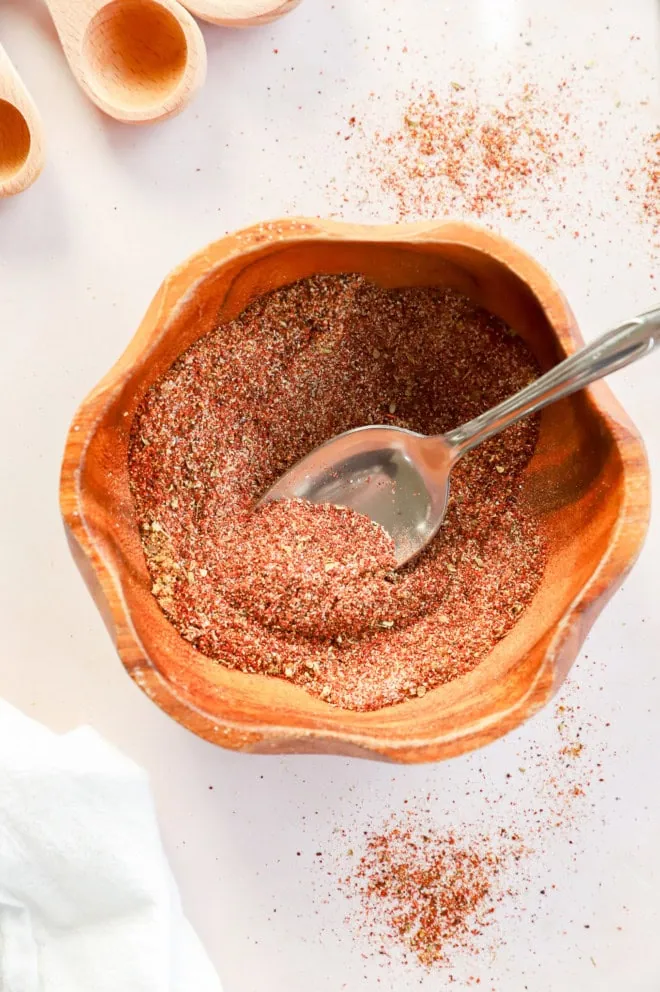 bowl of homemade chili seasoning recipe with spoon and measuring spoons