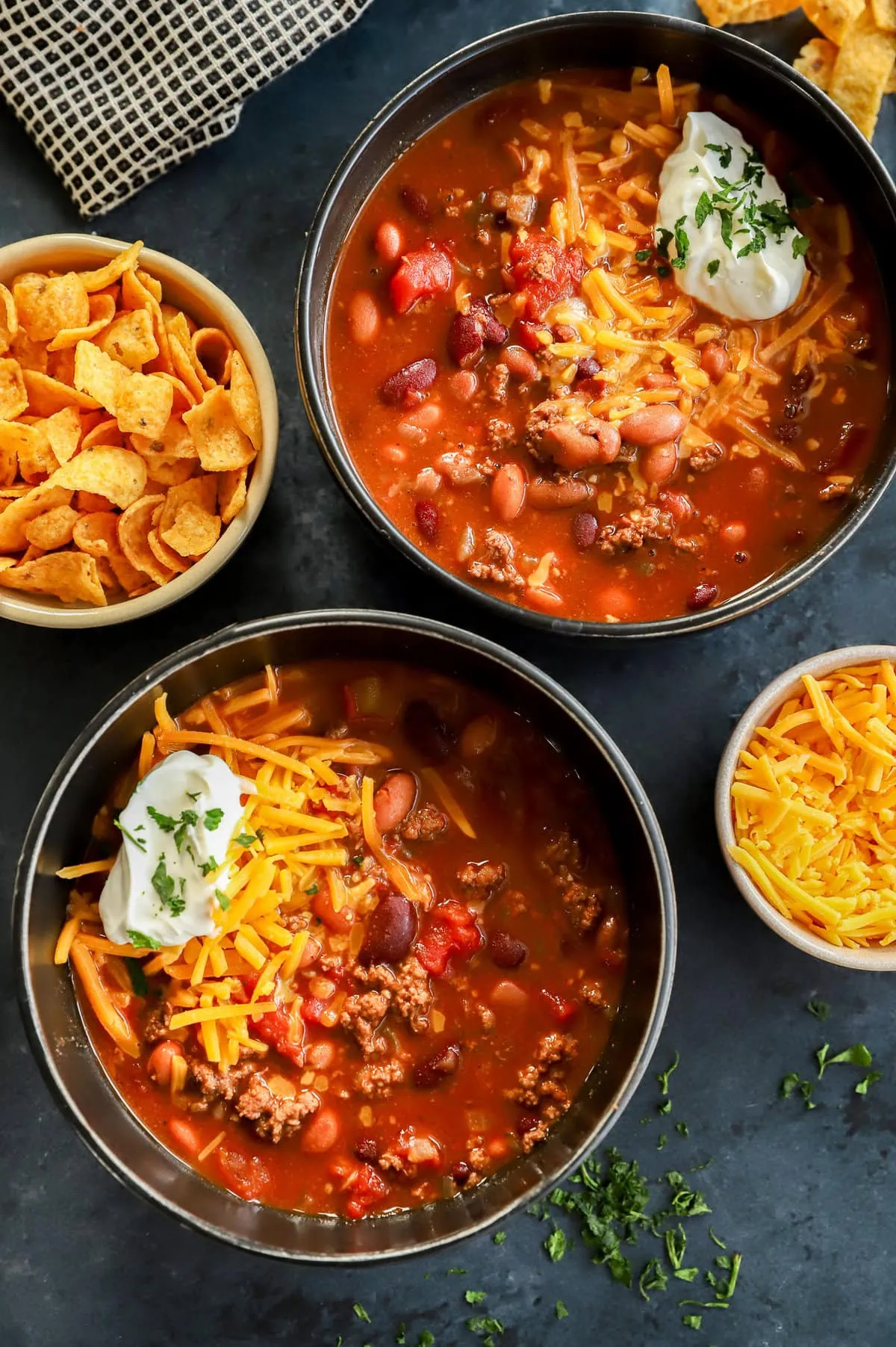 bowls of homemade beef stew with cheese sour cream on top