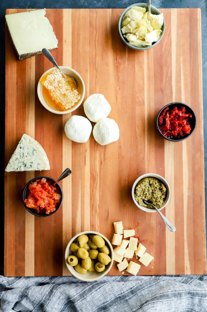 cheese added to cutting board for appetizer spread