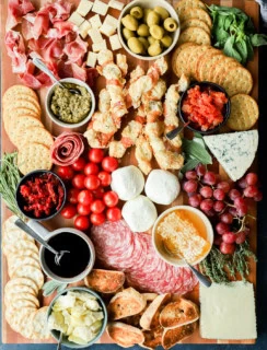 easy meat and cheese spread on cutting board with fresh produce