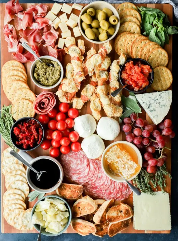 easy meat and cheese spread on cutting board with fresh produce