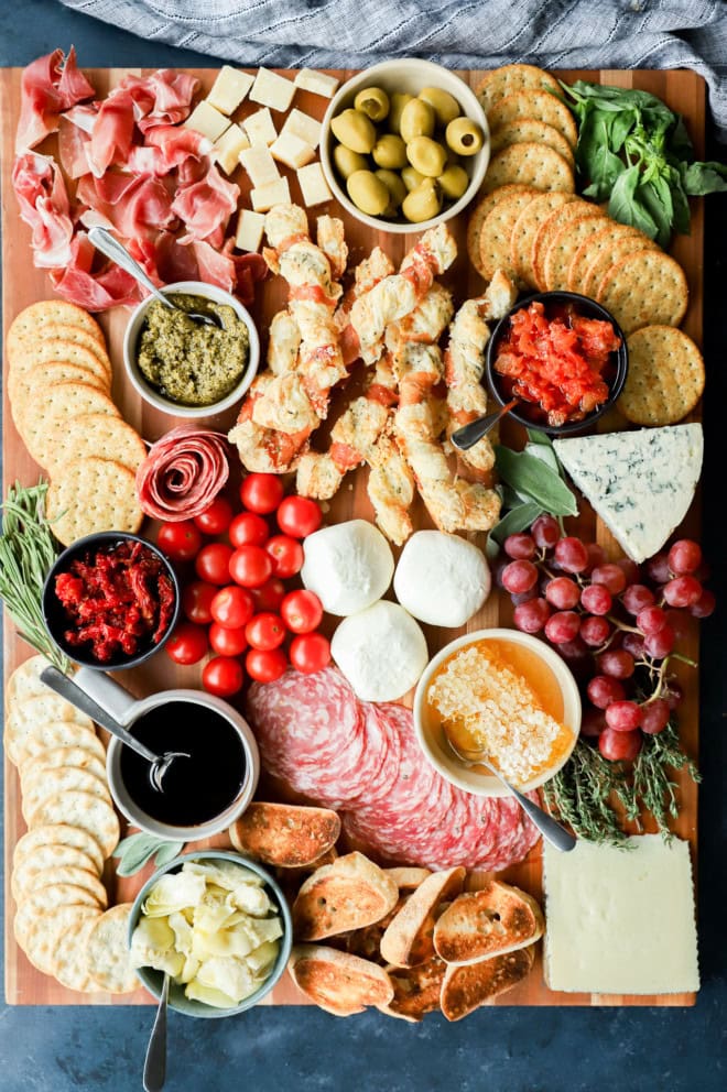 easy meat and cheese spread on cutting board with fresh produce