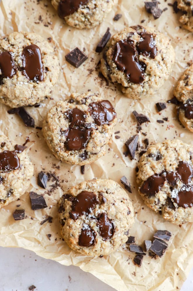 oatmeal chocolate chunk cookies on parchment paper with chocolate chunks