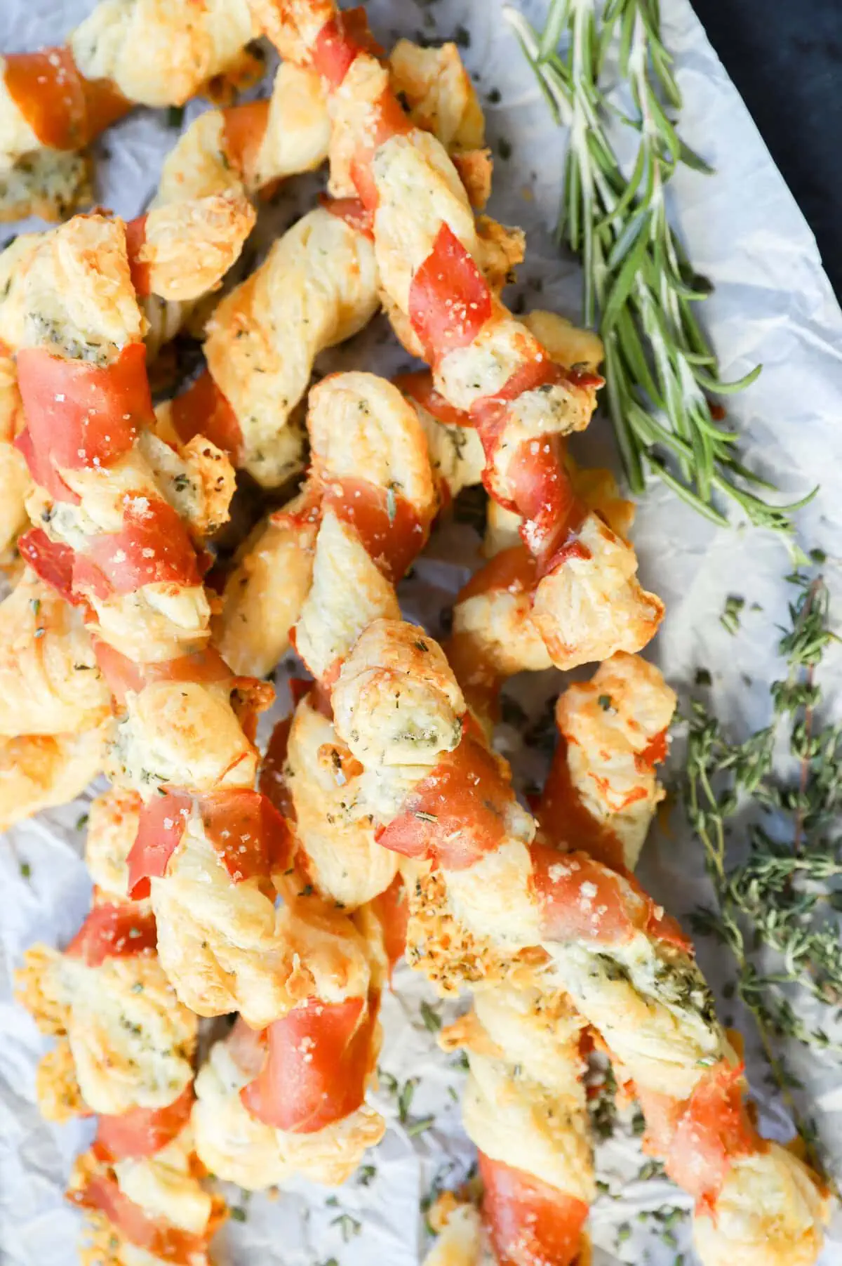 easy puff pastry italian appetizer on parchment paper with fresh herbs