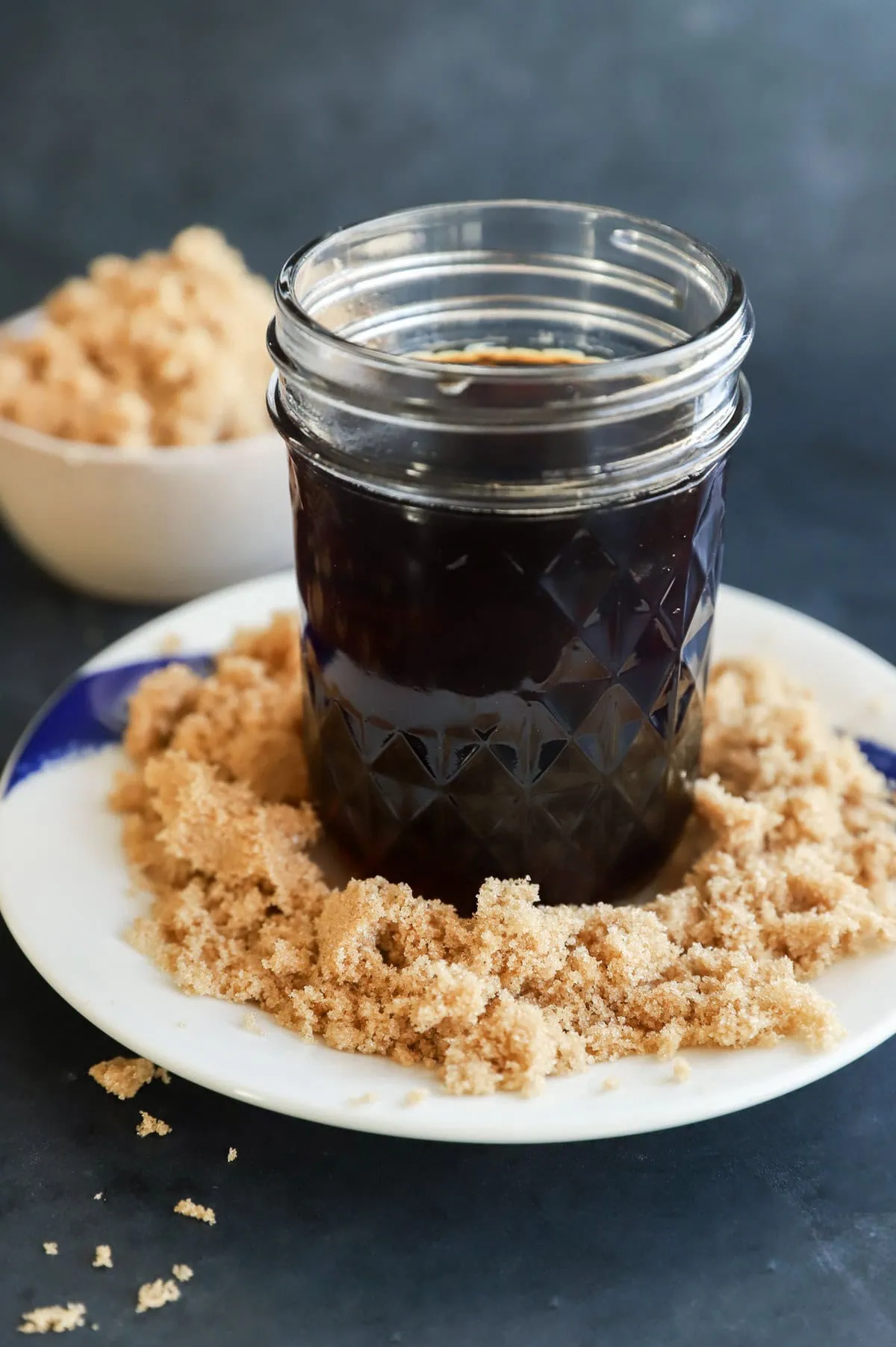 mason jar of brown sugar simple syrup with brown sugar on the plate