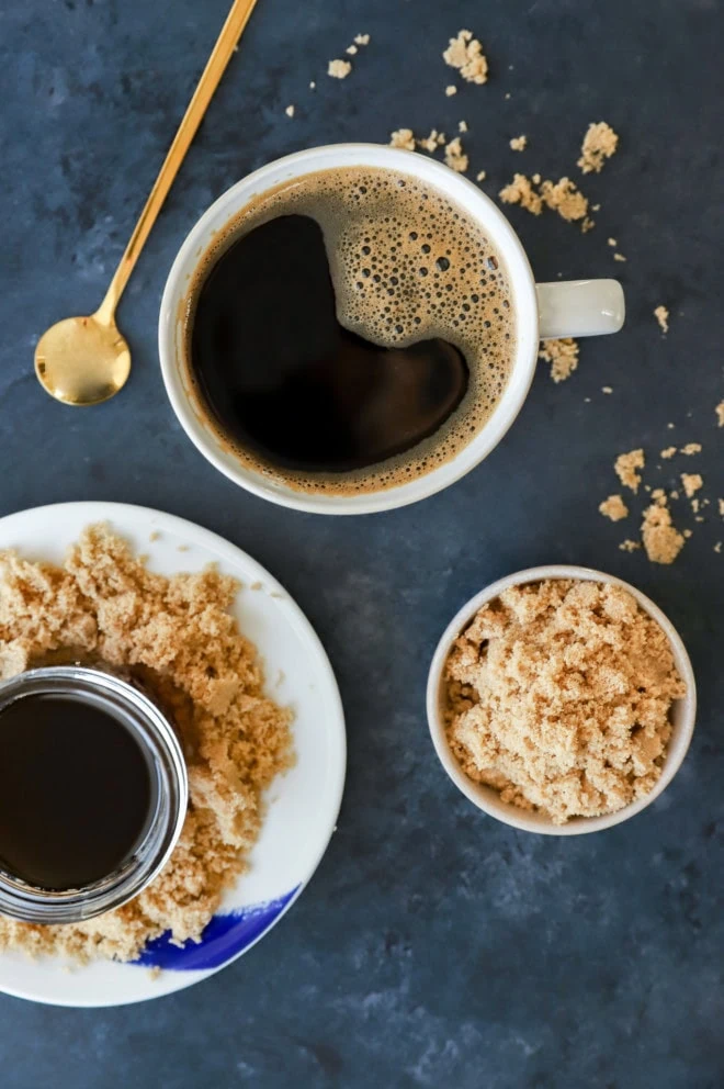 coffee mug with dark coffee and sweetener