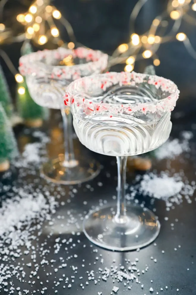 peppermint martini in coupe glasses with twinkle lights