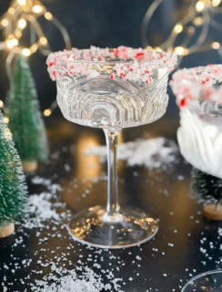 peppermint martini in coupe glass with little trees and lights