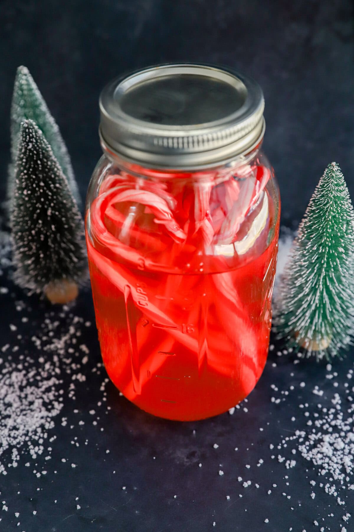 candy cane liquor in bottle with candies and fake snow