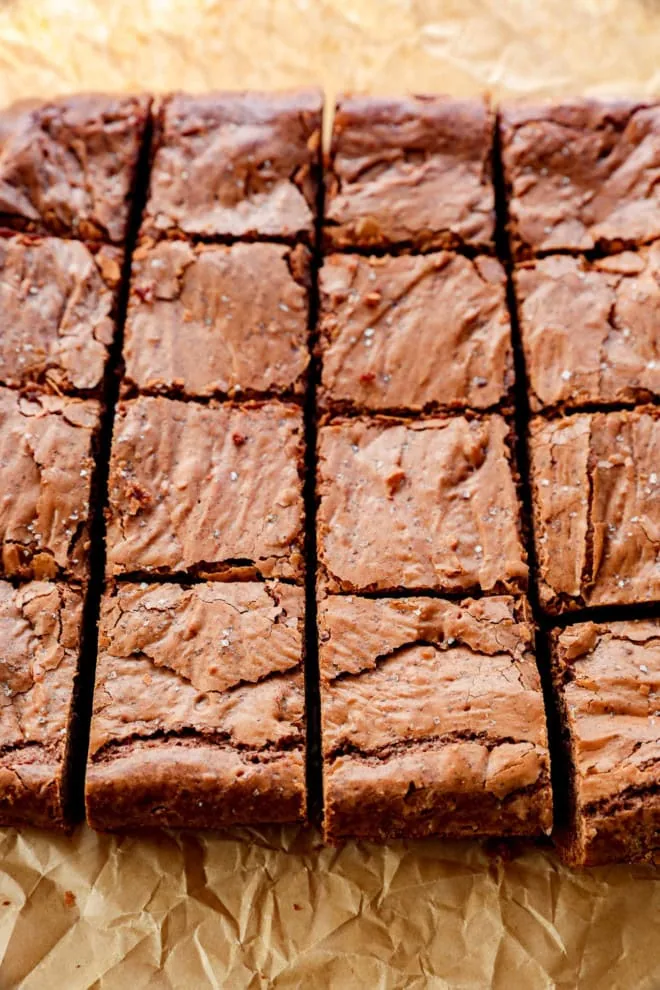 sliced coffee brownies with flaky sea salt on parchment paper