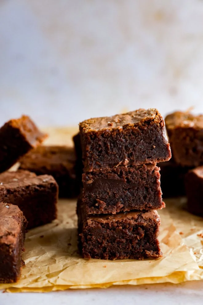 stack of chocolate baked treats on parchment paper