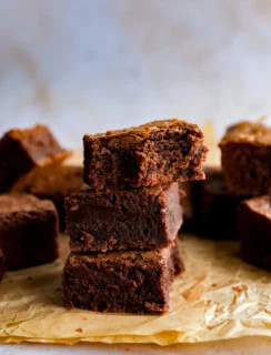 stack of coffee brownies with flaky sea salt on paper