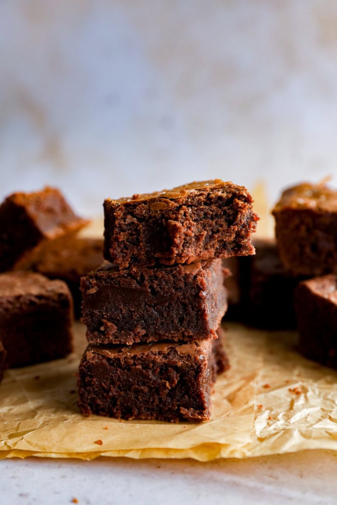 stack of coffee brownies with flaky sea salt on paper