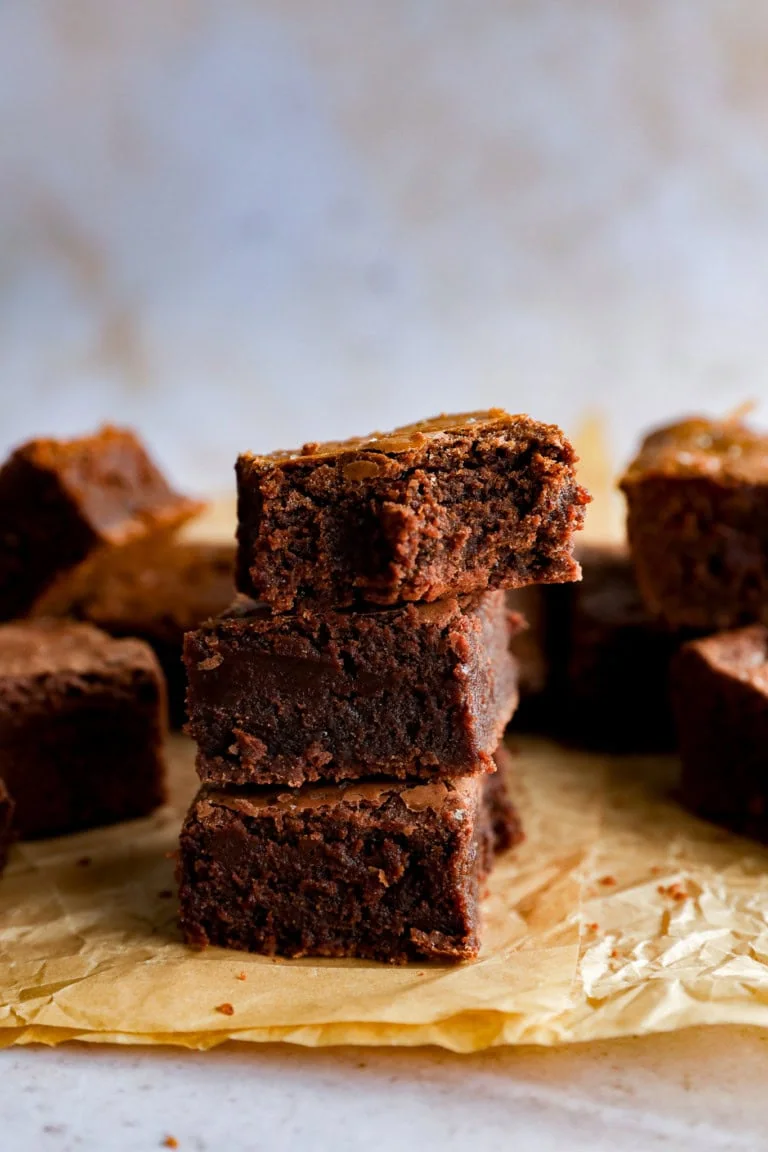 stack of coffee brownies with flaky sea salt on paper