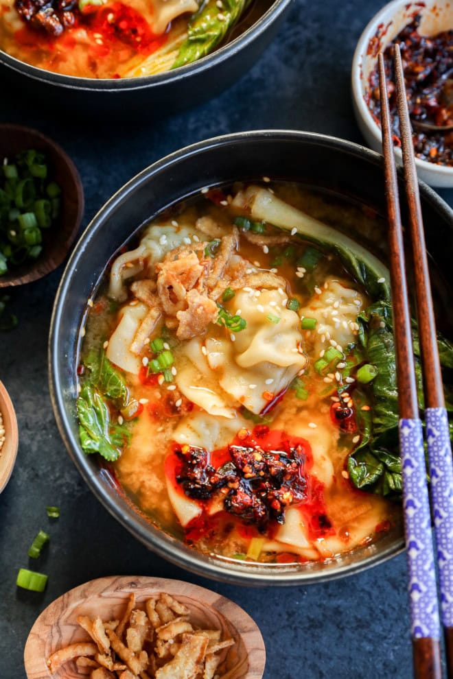 easy asian broth in bowls with chopsticks, bok choy and chili crisp