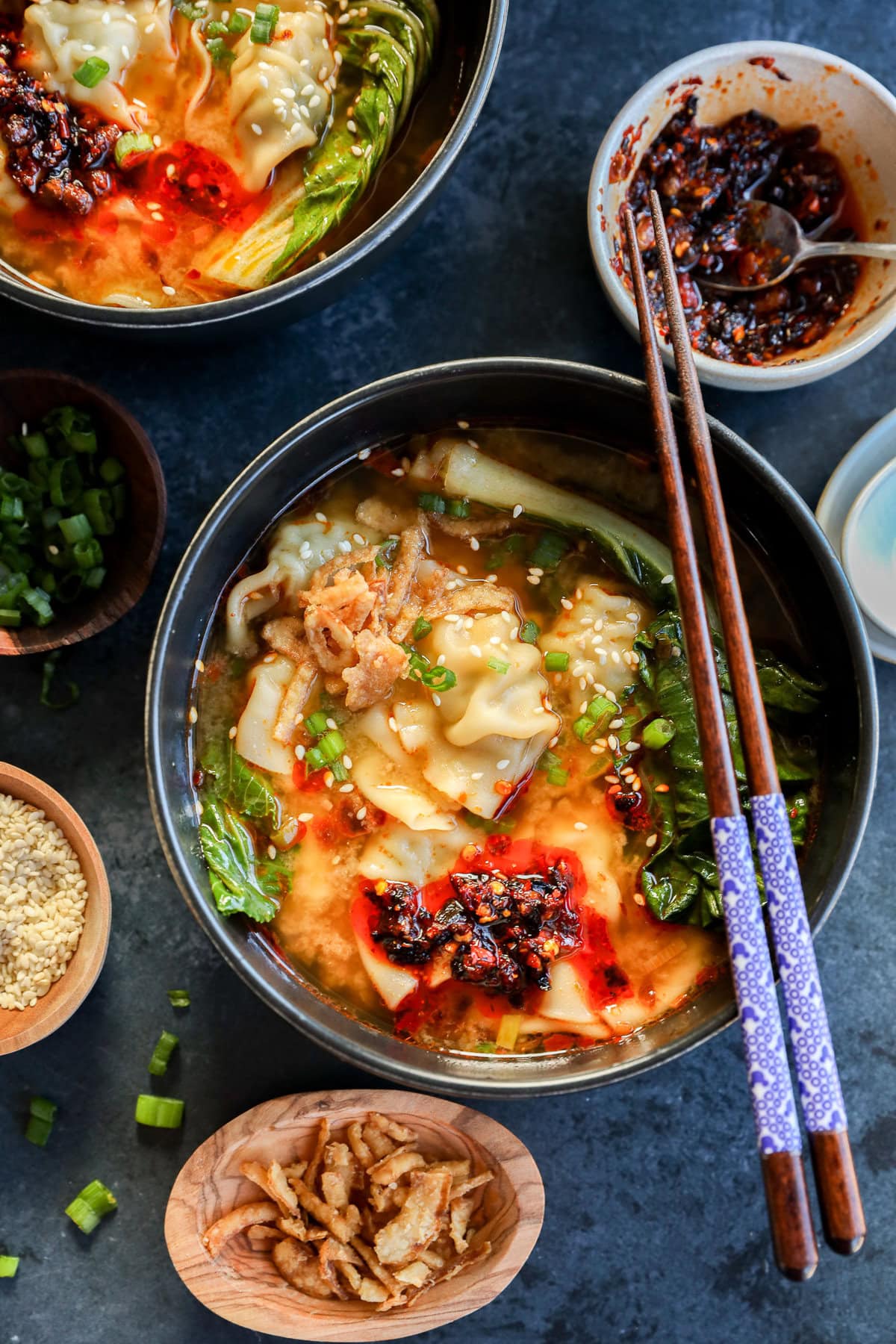 30 minute dumpling soup in bowls with chopsticks and chili crisp